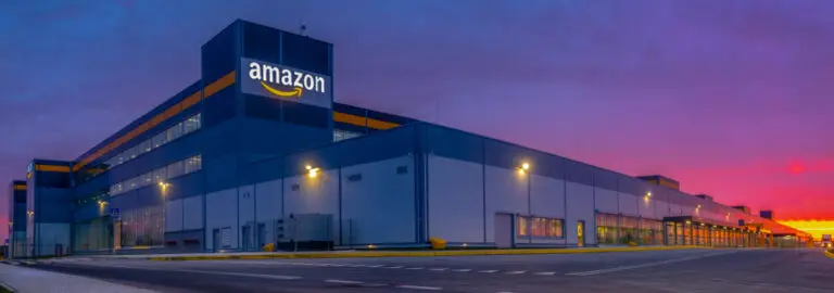 A bustling amazon warehouse at dusk, filled with workers diligently processing orders for the Amazon Affiliate Program.