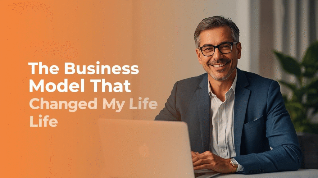Smiling man in a suit sitting at a desk with a laptop; text reads "The New Business Model That Uplifted My Life.